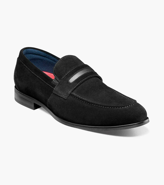 The Stacy Adams Burke Moc Toe Saddle Slip On (25676-008) is a black suede loafer with a low heel, rounded toe, decorative strap, and cushioned footbed by STACY ADAMS, shown on a white background.