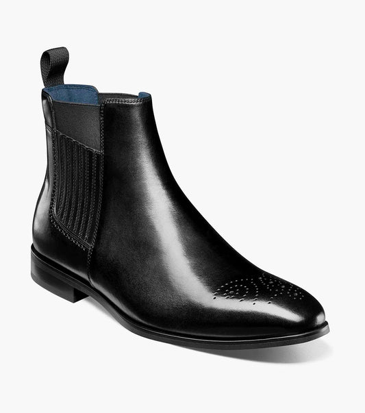 The Stacy Adams Bradley Plain Toe Chelsea Boot in black (25677-001) by STACY ADAMS features a molded heel cup, FLEXZONE branding, anatomical arch support, a cushioned heel pod, and plush Memory Foam footbed against a dark background.