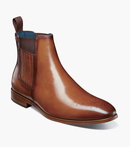 The STACY ADAMS Bradley Plain Toe Chelsea Boot in tan features anatomical arch support, elastic side panels, a pull tab, and decorative toe perforations. Displayed on a white background.
