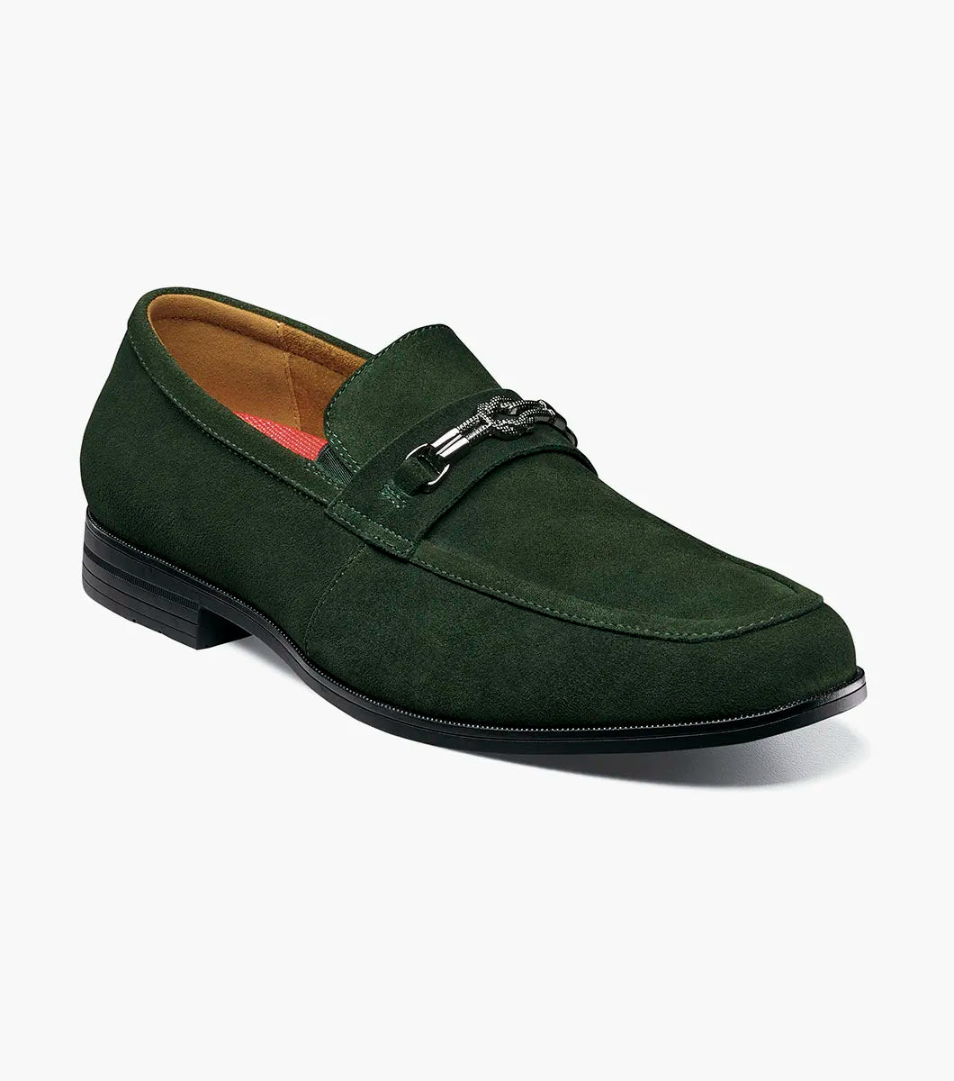 The STACY ADAMS Ravelle Moc Toe Bit Slip On in Washed Green (25680-344) is a green suede loafer with a low heel, metal bit detail, and cushioned footbed for comfort, displayed on a plain white background.