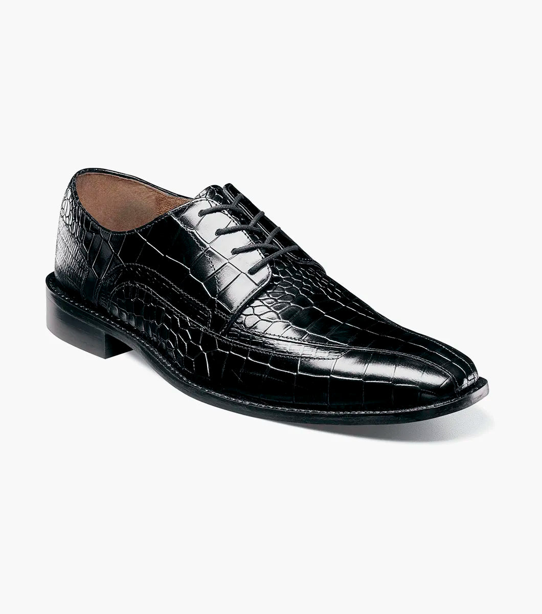 The STACY ADAMS Gabardo Bike Toe Oxford in black (25681-001) is a crocodile-textured leather dress shoe with lace-up closure, a low heel, and memory foam cushioning for comfort, shown on a white background.