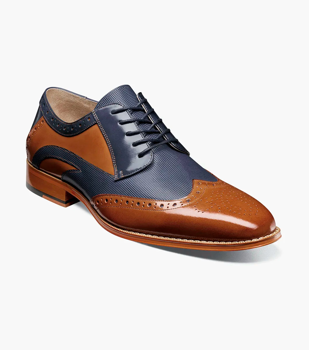 The Stacy Adams Ivingale Wingtip Oxford (Tan Multi) features brown leather and navy panels, brogue details, laces, a memory foam footbed, and a brown sole. Model: 25684-238.