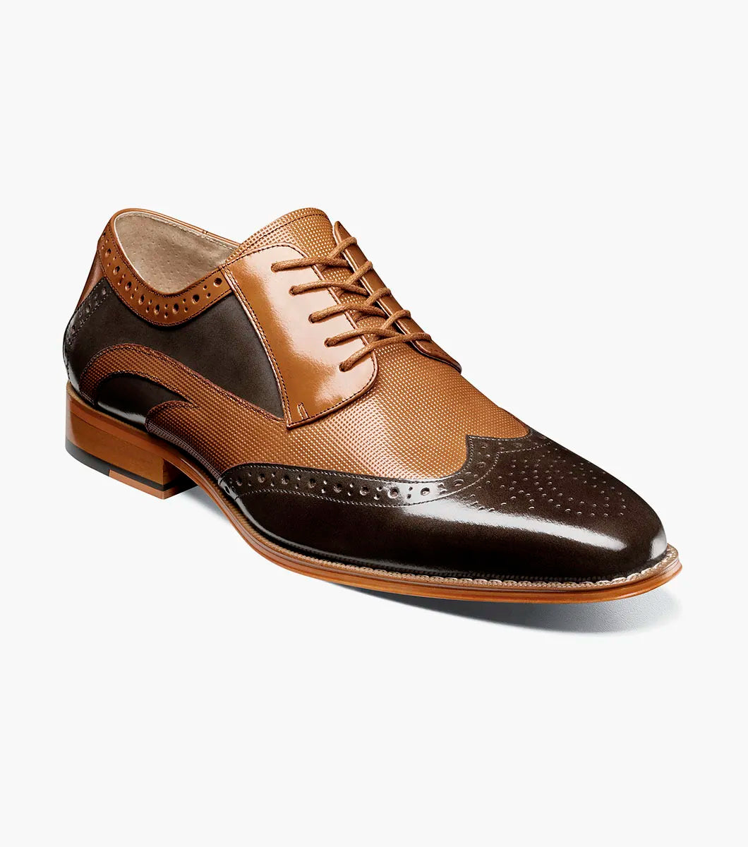 The Stacy Adams Ivingale Wingtip Oxford (Brown Multi, style 25684-249) features brogue detailing, laces, a memory foam footbed, and a low stacked heel. Shown in two-tone brown leather against a white background.