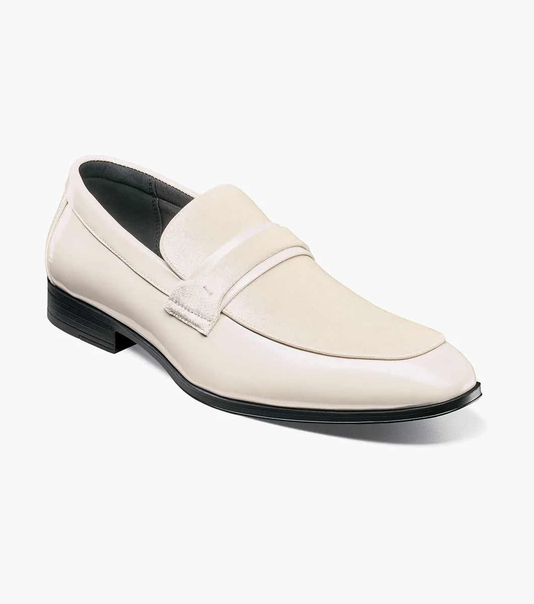 The STACY ADAMS Spratley Moc Toe Saddle Slip On in ivory features a cream velour upper with suede panel, low black heel, and almond toe for a sophisticated men's loafer.