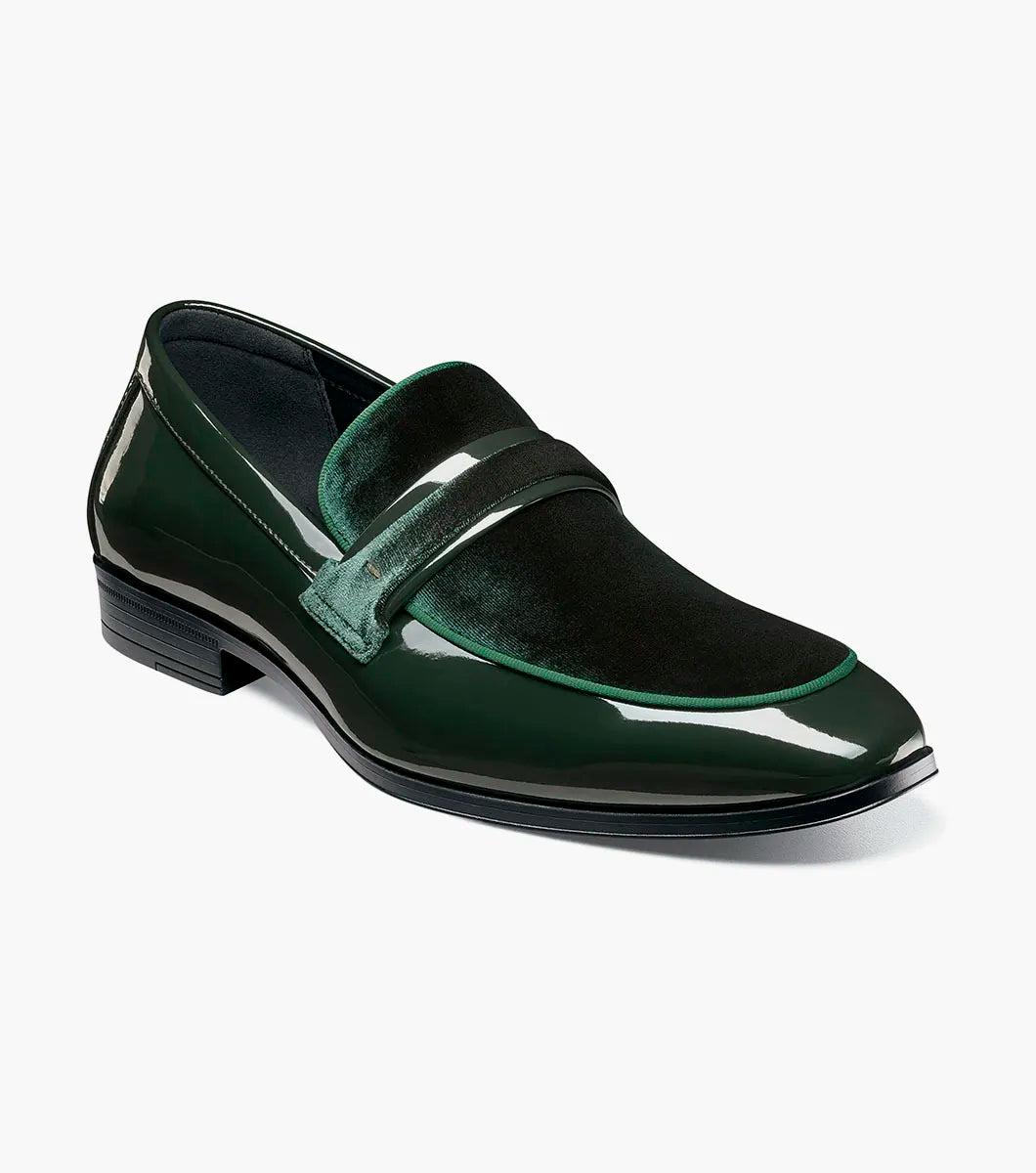 The Stacy Adams Spratley Moc Toe Saddle Slip On in dark green patent leather features a black sole, elegant velour upper, and velvet accents along the upper and tongue.