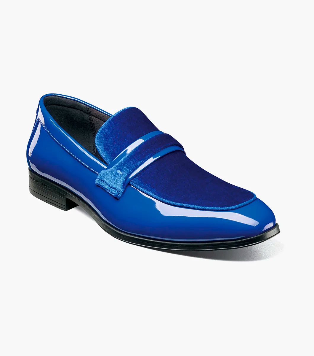 The STACY ADAMS Spratley Moc Toe Saddle Slip On in Royal (25686-432) features a shiny blue velour upper with a patent leather finish, shown in a side profile on a white background.