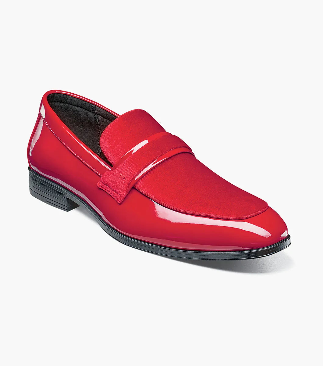 The Stacy Adams Spratley Moc Toe Saddle Slip On in red features a velour upper, matte strap, and black sole. This single shiny loafer (25686-600) by STACY ADAMS is displayed on a white background.