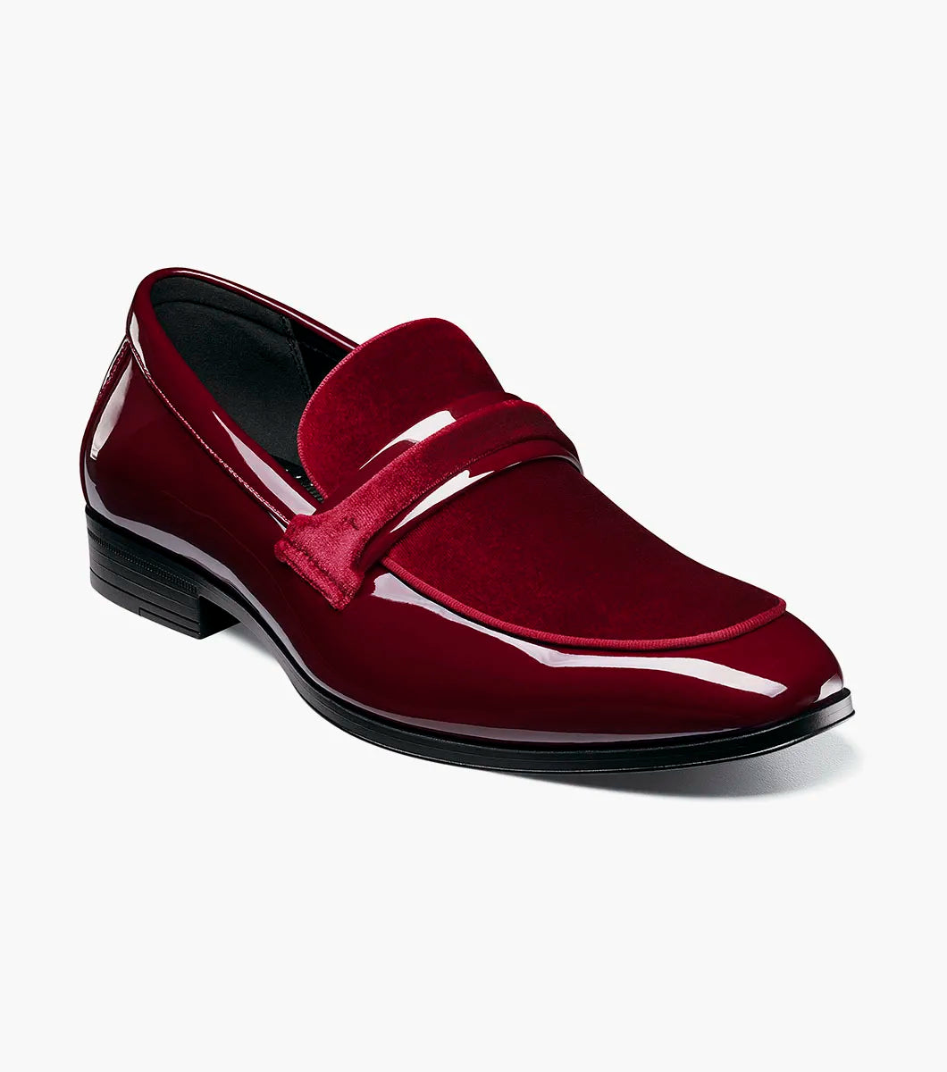 The STACY ADAMS Spratley Moc Toe Saddle Slip On (Burgundy, 25686-601) is a men's loafer with a low heel, combining a velour upper, suede vamp, and glossy patent leather finish.