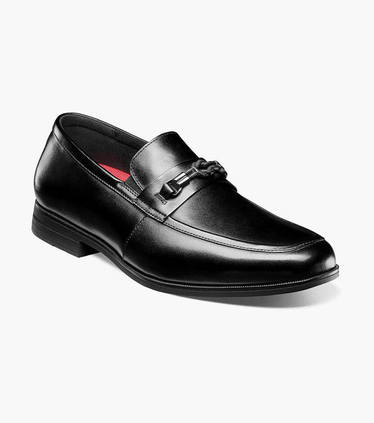 The Stacy Adams Rellaire Moc Toe Bit Slip On in black features a low heel, metal bit detail, and RedZone footbed comfort by STACY ADAMS, shown on a white background.
