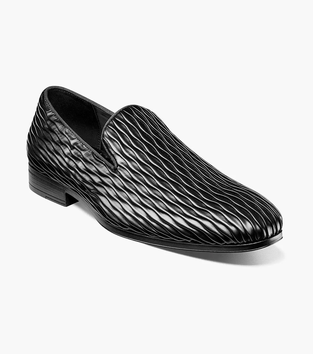 The Stacy Adams Seismith Plain Toe Slip On in black (style 25688-001) features a textured wavy pattern and a Memory Foam footbed, shown against a white background.