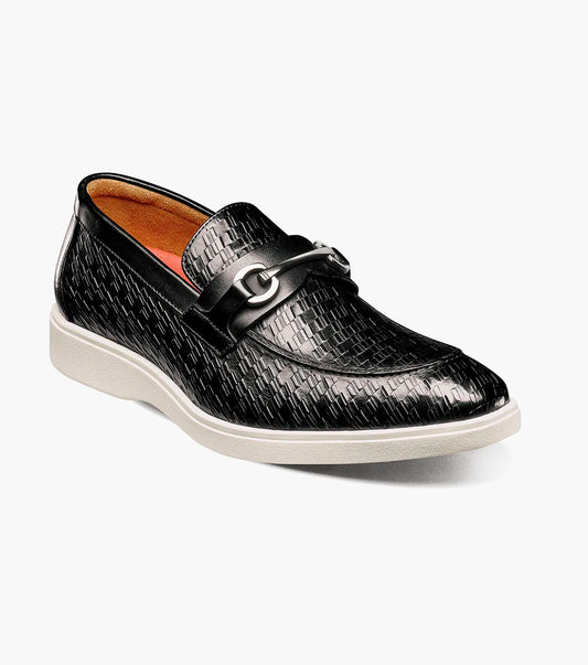 The STACY ADAMS Salyer Moc Toe Bit Slip On (25692-001) features black textured leather, a metal bit detail, and a white sole—perfect for dress occasions, shown on a plain white background.