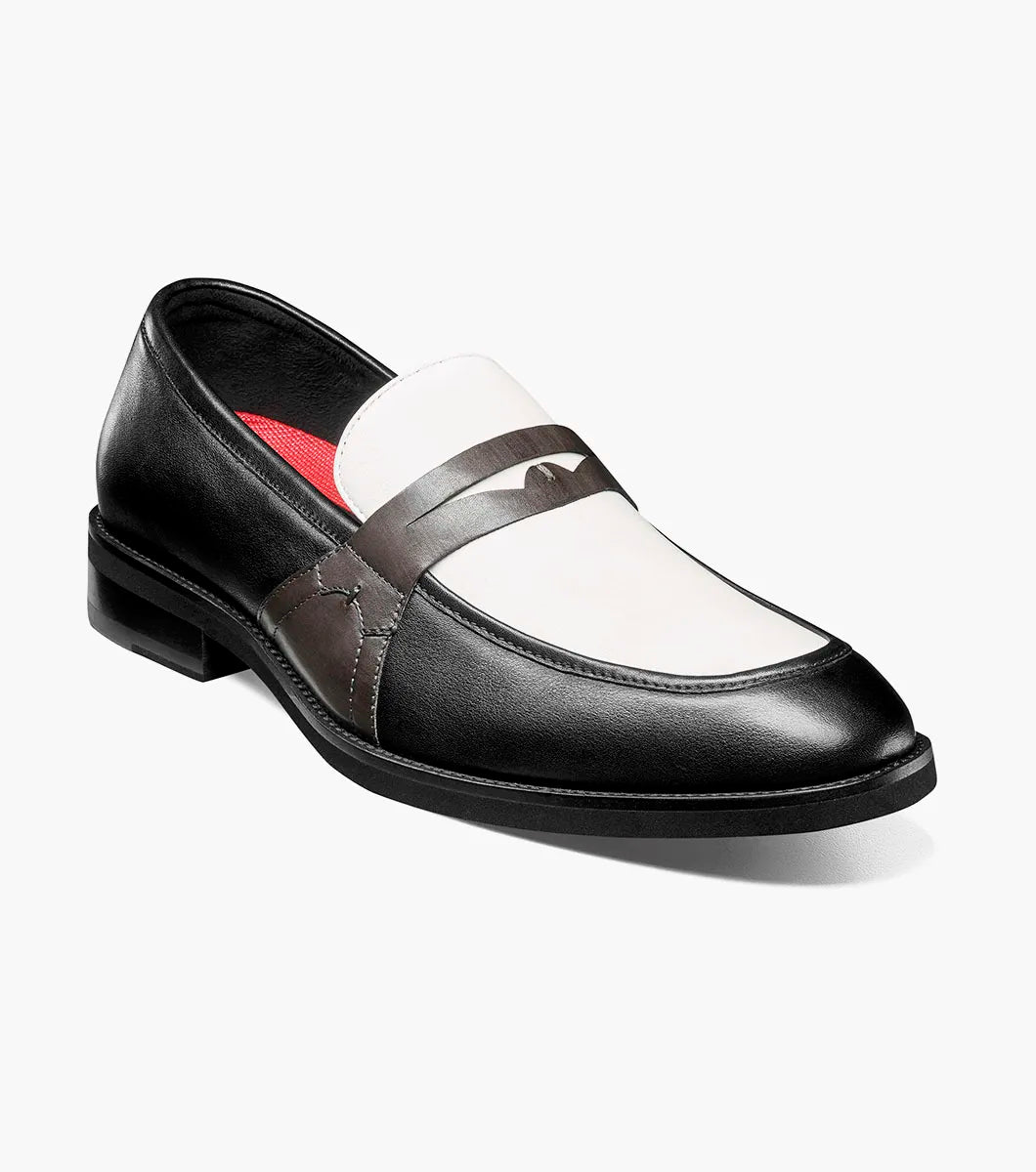 The Stacy Adams Prichard Moc Toe Penny Slip On features a black and grey leather upper with a low heel, shown from the side against a plain white background. Brand: STACY ADAMS. Style: 25693-910.