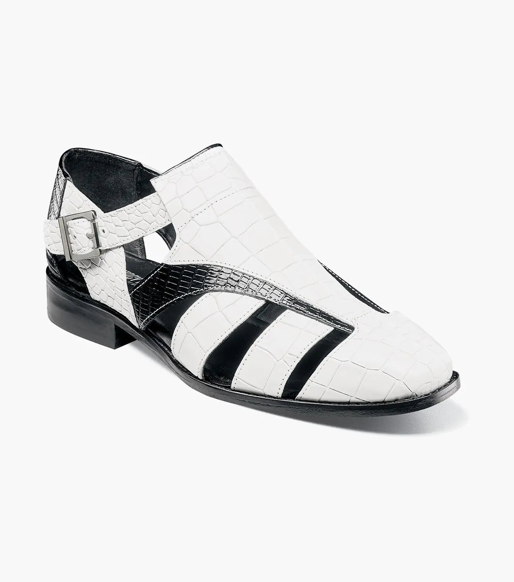 The Stacy Adams Calandro City Sandal (25695-111) features a black and white closed-toe design with cut-out sections, buckle strap, low heel, textured crocodile print leather, and a genuine leather sole.