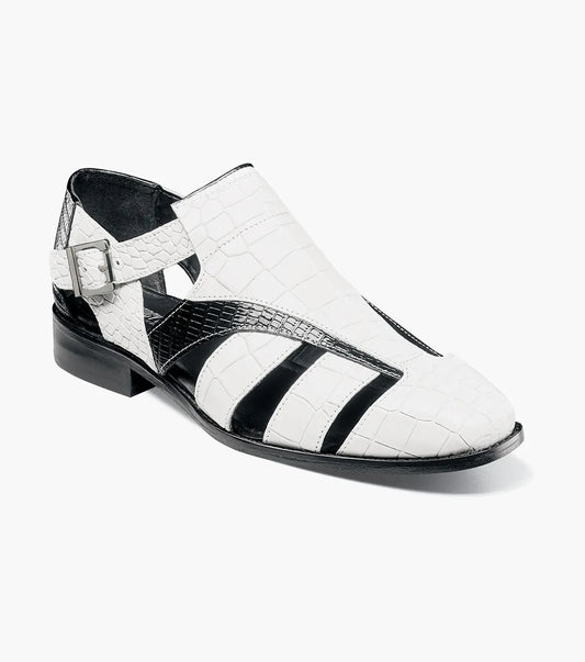 The Stacy Adams Calandro City Sandal (25695-111) features a black and white closed-toe design with cut-out sections, buckle strap, low heel, textured crocodile print leather, and a genuine leather sole.