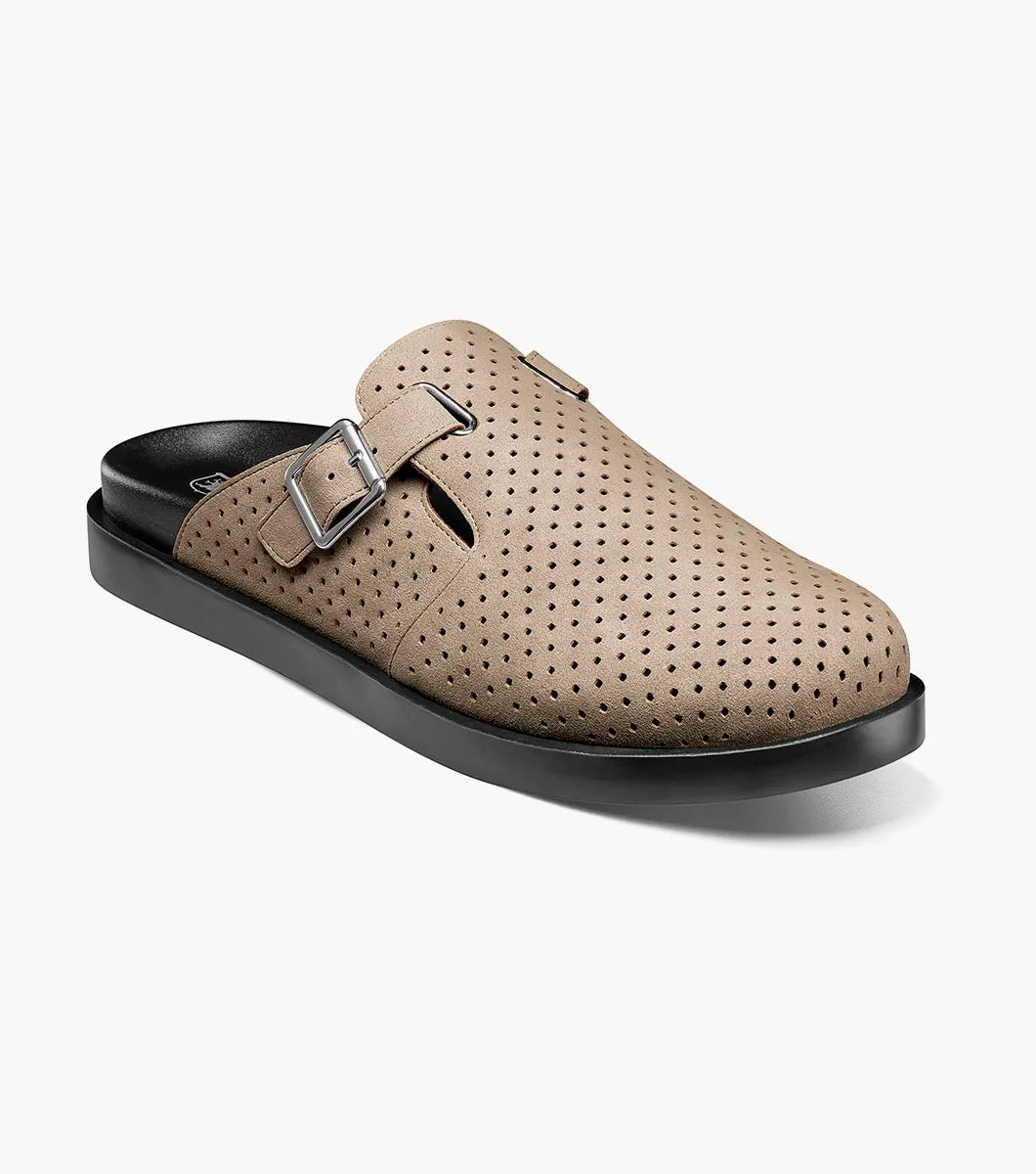 The Stacy Adams Montaine Strap Sandal in sand is a beige perforated slip-on mule with a side buckle, black sole, and EVA midsole—ideal for summer. Brand: STACY ADAMS. Model: 25696-269. Displayed on a white background.