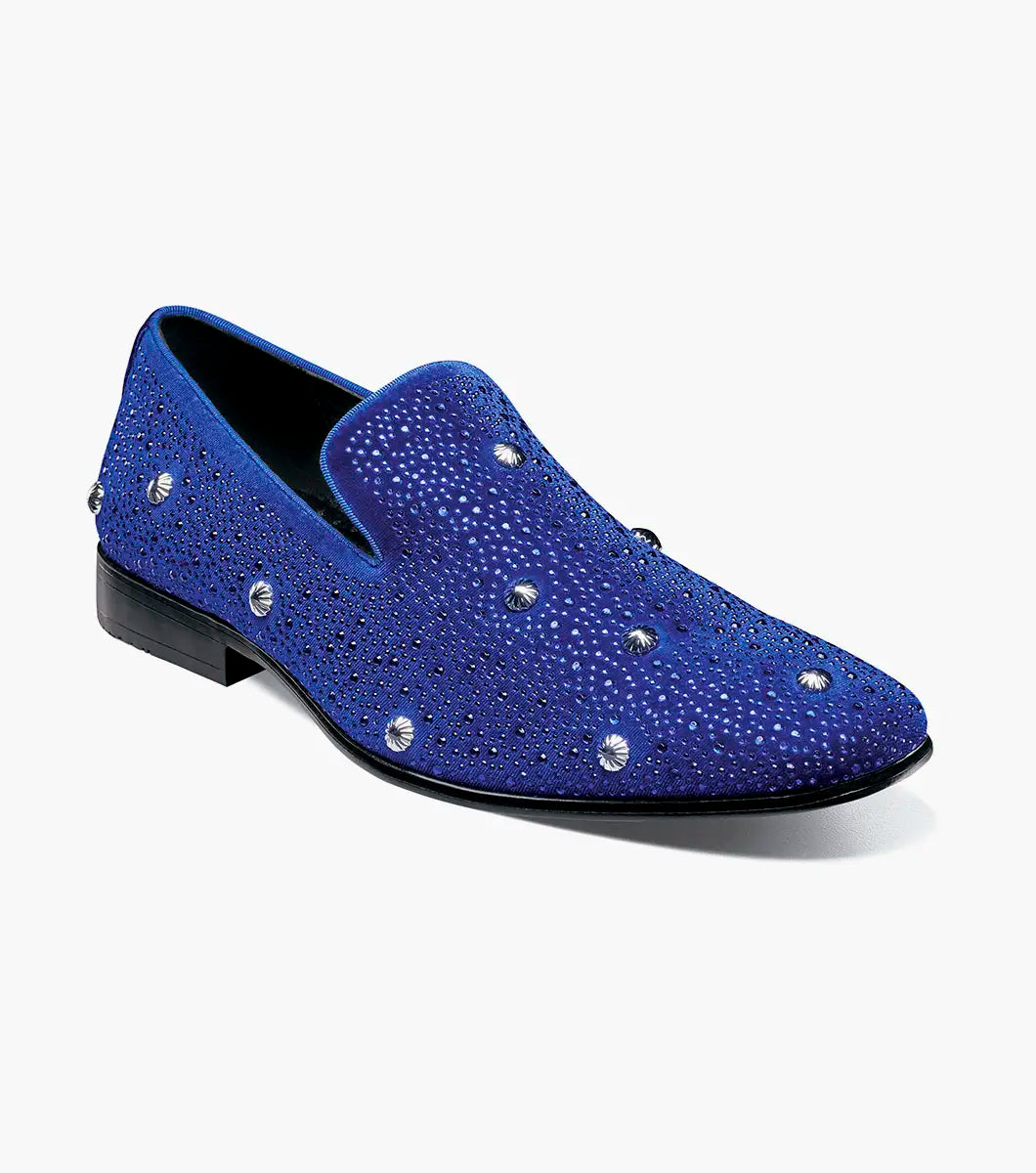 The Stacy Adams Spangle Rhinestone Slip On (Royal, 25699-432) by STACY ADAMS, features satin fabric with small rhinestones and large round gems. The loafer is displayed in profile against a white background.