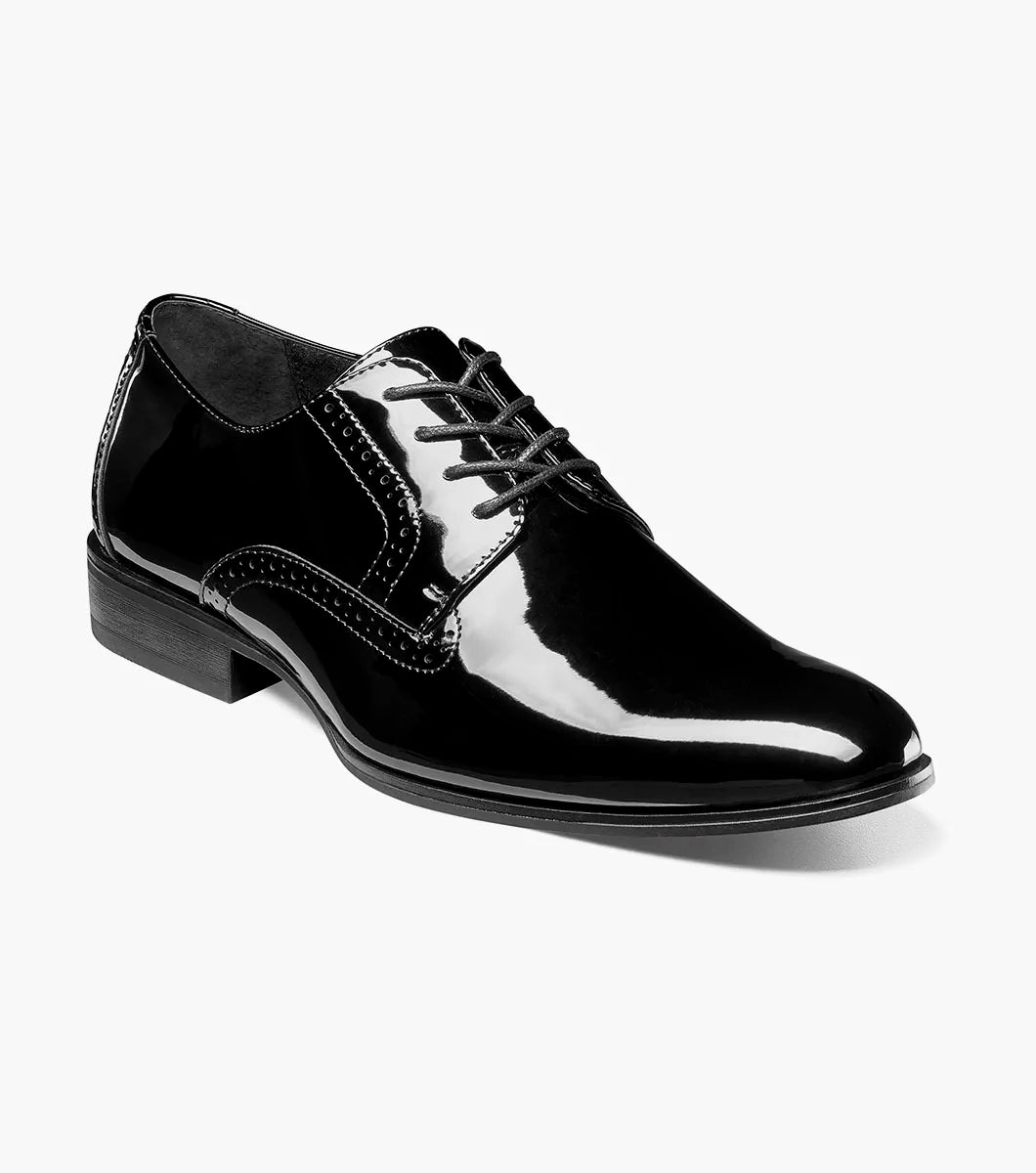The STACY ADAMS Scottie Plain Toe Oxford (Black Patent, 25701-004) is a black patent leather lace-up dress shoe with anatomical arch support, shown in side profile against a white background.