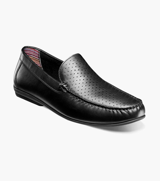 The Stacy Adams Conroy Moc Toe Perf Slip On (Black, 25702-001) features a perforated leather upper, visible stitching, low heel, striped inner lining, and cushioned footbed.