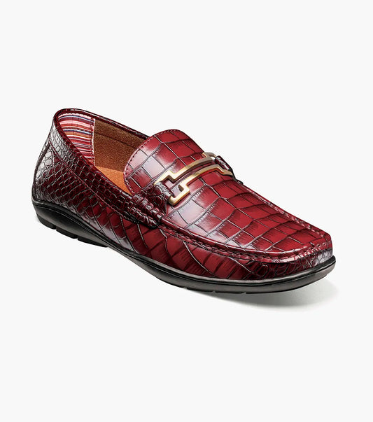 The STACY ADAMS Embrey Moc Toe Bit Slip On in Wine (25703-609) features a single red crocodile print loafer with a metal bit detail on the man-made upper, shown against a white background.