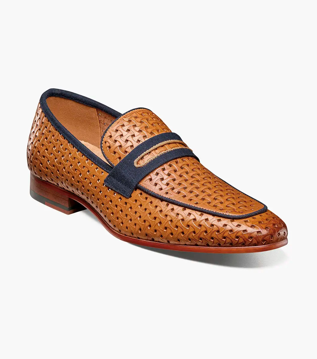The STACY ADAMS Winstead Moc Toe Saddle Slip On in Natural features a brown woven leather upper, dark blue trim, Memory Foam insole, and low heel, displayed on a white background.