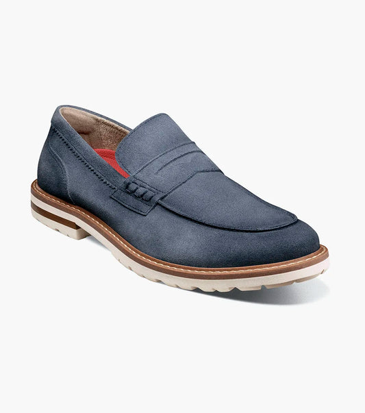 The Stacy Adams Hopkins Moc Toe Penny Slip On in navy suede features a moc toe, penny strap, white and tan rubber sole, and visible stitching, shown on a plain white background for comfort and style.