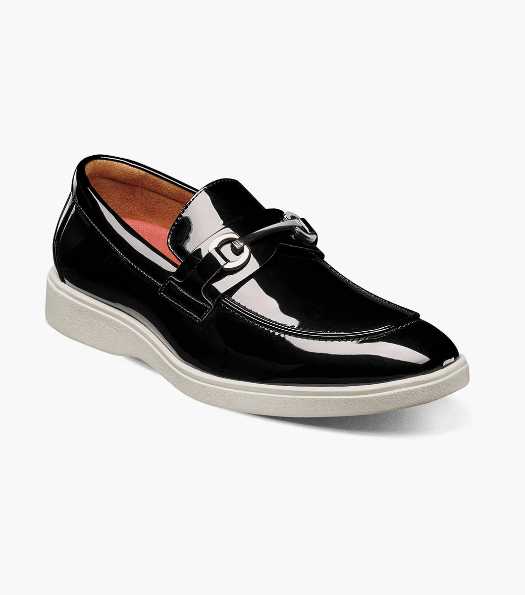 The Stacy Adams Slayton Moc Toe Bit Slip On (25710-004) is a black patent leather loafer with a white sole, displayed in side profile against a plain white background.