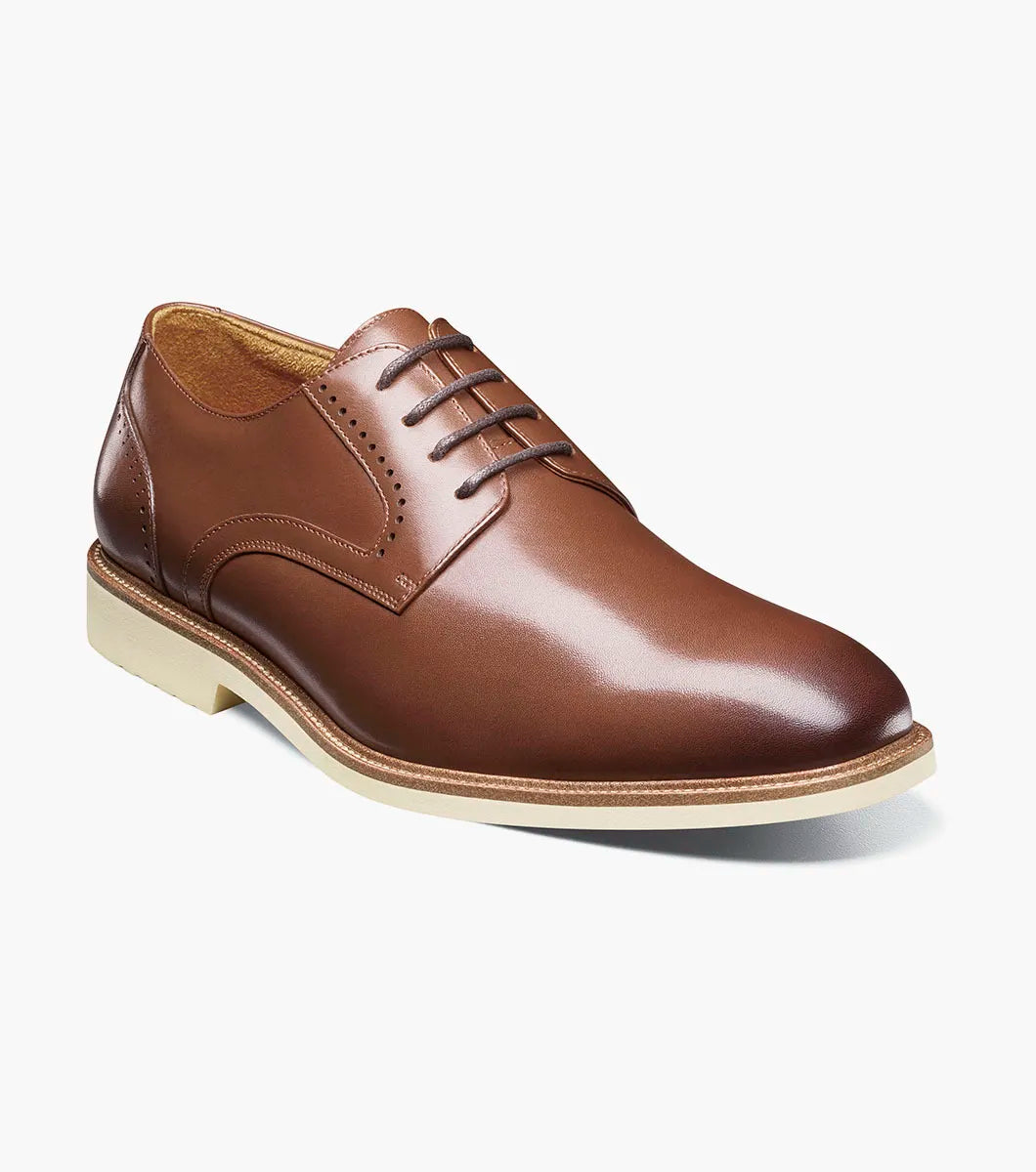 The Stacy Adams Wescott Plain Toe Oxford in chocolate features a rounded toe, brown laces, and a light sole with anatomical arch support. Stylishly classic, it’s shown against a white background.