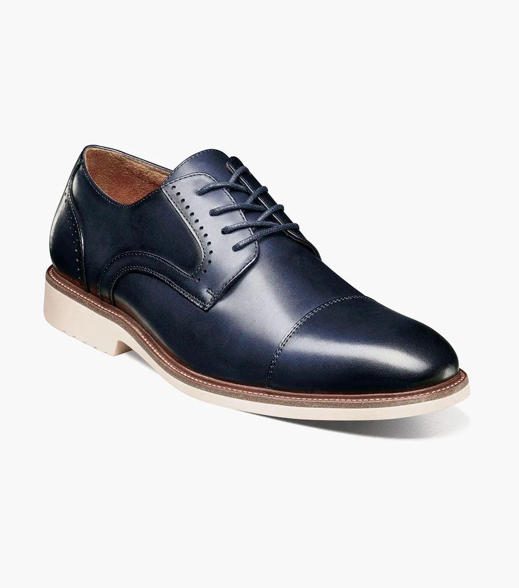 The Stacy Adams Wesbridge Cap Toe Oxford (Navy, 25713-410) is a navy blue burnished leather dress shoe with matching laces and a light-colored sole, displayed in side profile on a white background.