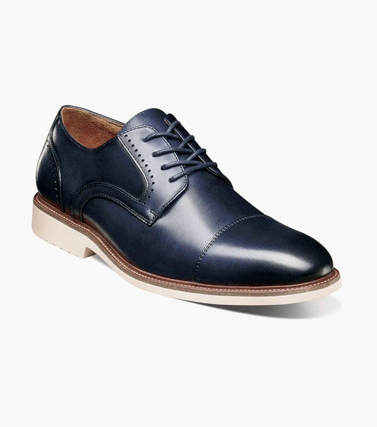 The Stacy Adams Wesbridge Cap Toe Oxford (Navy, 25713-410) is a navy blue burnished leather dress shoe with matching laces and a light-colored sole, displayed in side profile on a white background.