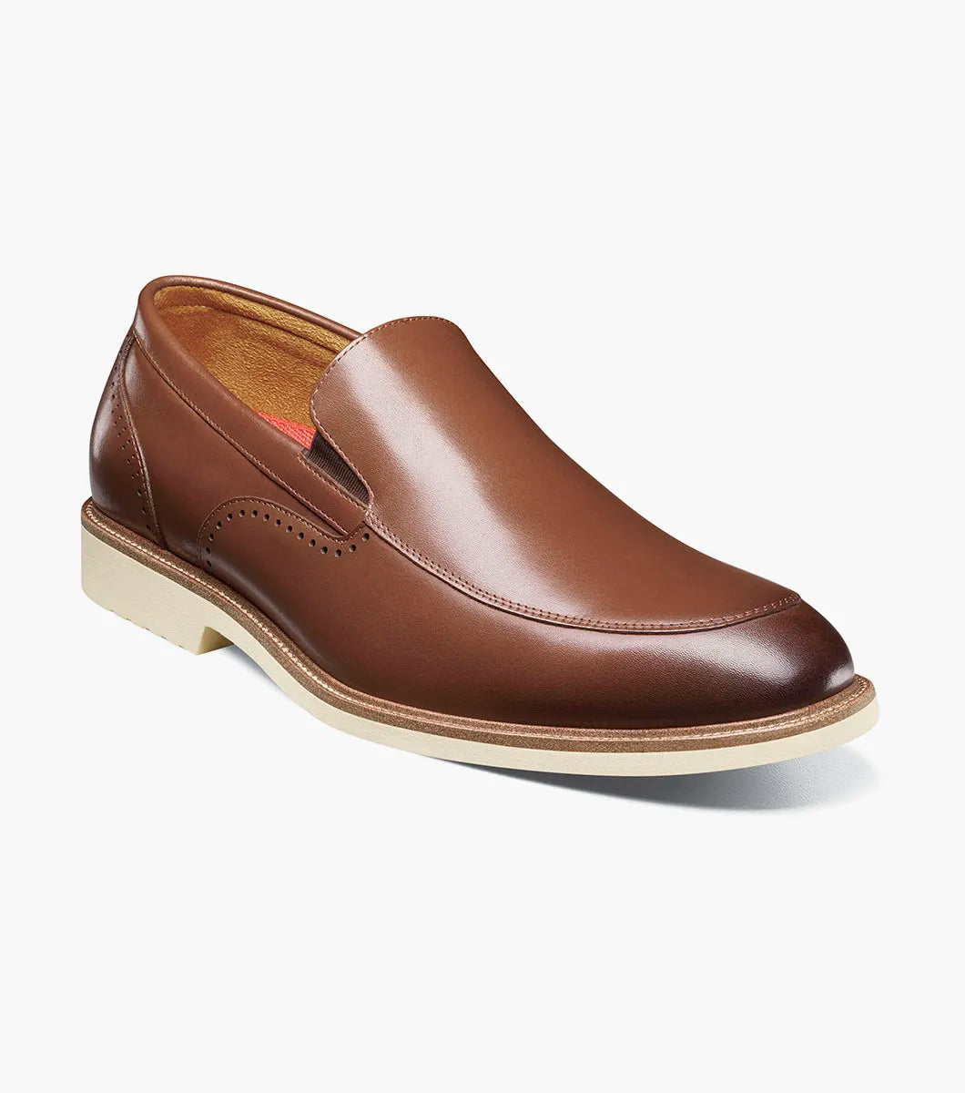 The STACY ADAMS Wellington Moc Toe Slip On in chocolate leather, style 25714-202, with a beige sole and anatomical arch support, is shown at a slight angle against a plain white background.