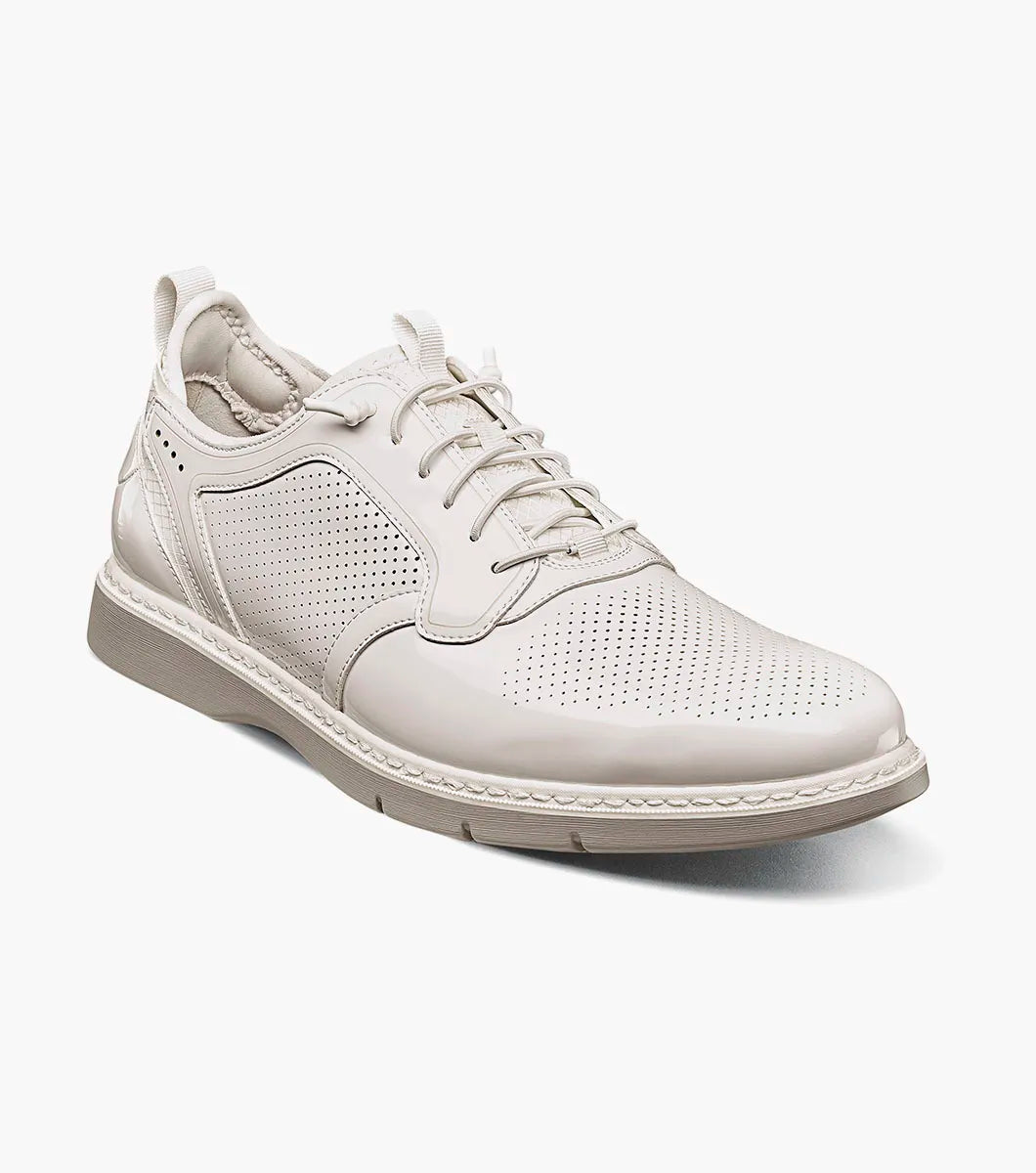 The Stacy Adams Spyre Plain Toe Elastic Lace Up in white patent features perforated detailing, a low heel, and back pull tab—ideal for those seeking stylish and comfortable men’s shoes.