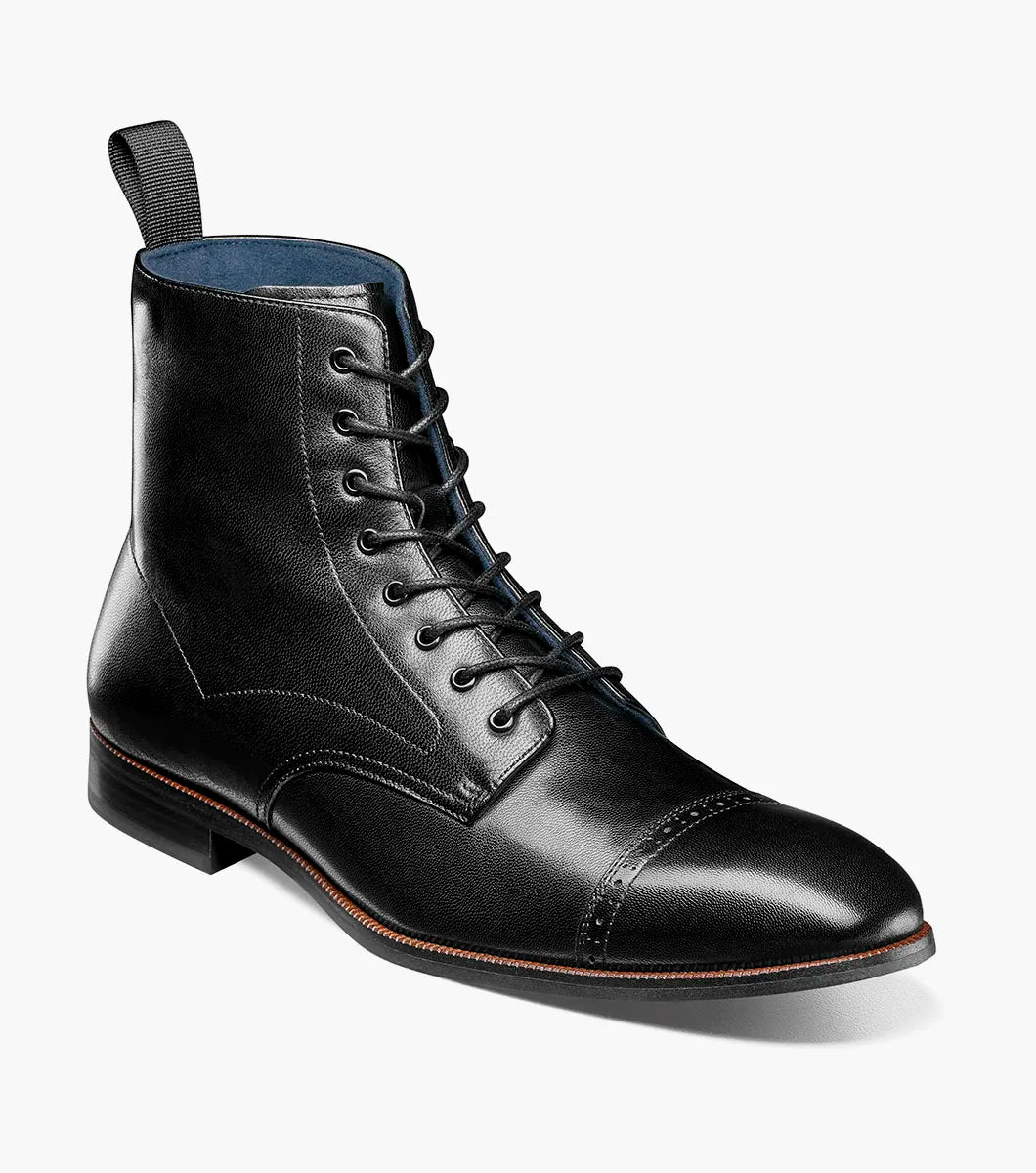 The STACY ADAMS Henry Cap Toe Lace Up Boot in black (25718-001) features leather construction, cap toe, side stitching, heel pull tab, low heel, and EVA sole—shown in side profile against a white background.