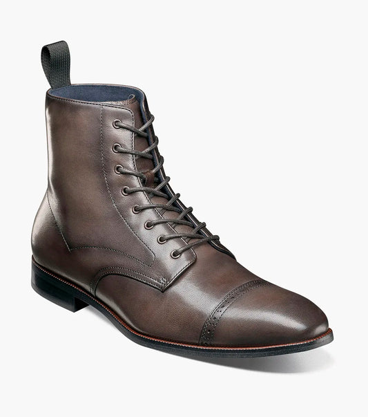 The STACY ADAMS Henry Cap Toe Lace Up Boot in gray (25718-020) features a leather upper, cap toe, side stitching, low black heel, and durable rubber outsole. Shown in side profile against a white background.