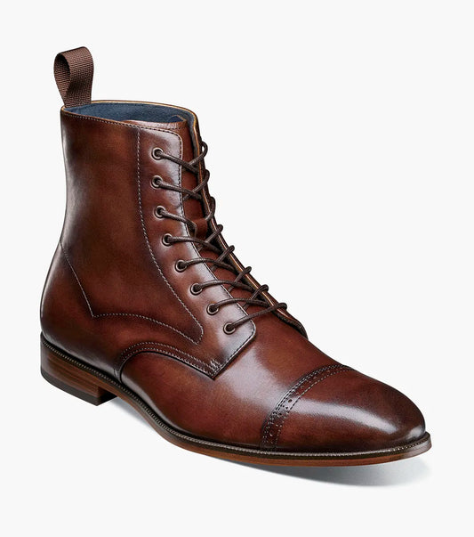 The STACY ADAMS Henry Cap Toe Lace Up Boot in brown (25718-200) features a leather upper, cap toe, decorative stitching, back pull tab, and anatomical arch support; shown on a white background.