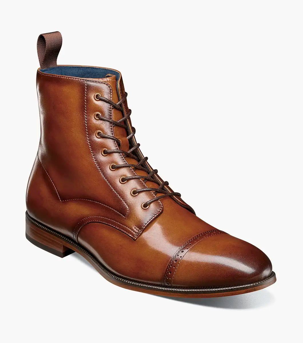 The Stacy Adams Henry Cap Toe Lace Up Boot in tan (style 25718-240) features a leather upper, decorative stitching, cap toe, low heel, and anatomical arch support. Shown in side profile against a white background.