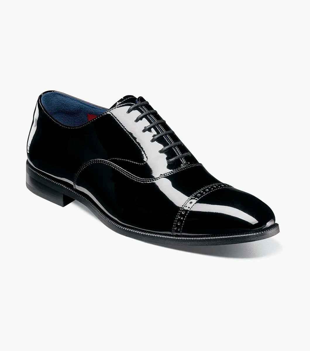 The Stacy Adams Concorde II Cap Toe Oxford (25721-004) is a black patent leather dress shoe with decorative stitching, black laces, and Goodyear Welt Construction, shown in side profile on a white background.