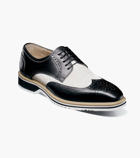 The STACY ADAMS Beaumont Wingtip Oxford (Black w/White, 25723-111) features leather linings, decorative perforations, wingtip styling, and a contrasting sole, shown in side profile on a white background.