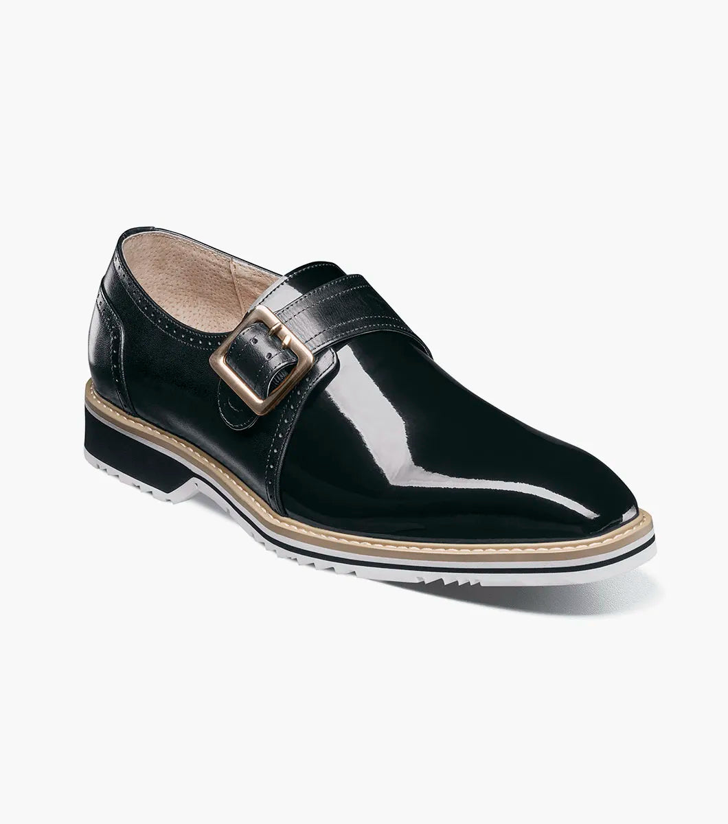 The STACY ADAMS Bartram Plain Toe Monk Strap (25724-001) is a black patent leather dress shoe with a silver buckle, low heel, leather upper, and a two-tone black and white sole.