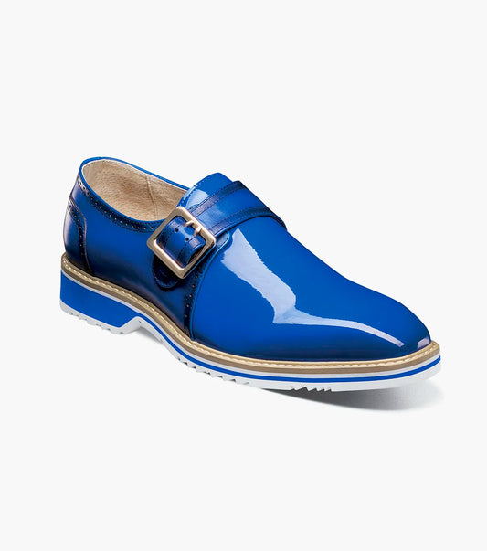 The Stacy Adams Bartram Plain Toe Monk Strap (25724-400) features a shiny blue leather upper, silver buckle, white sole, and tan midsole. Displayed in profile against a plain white background.