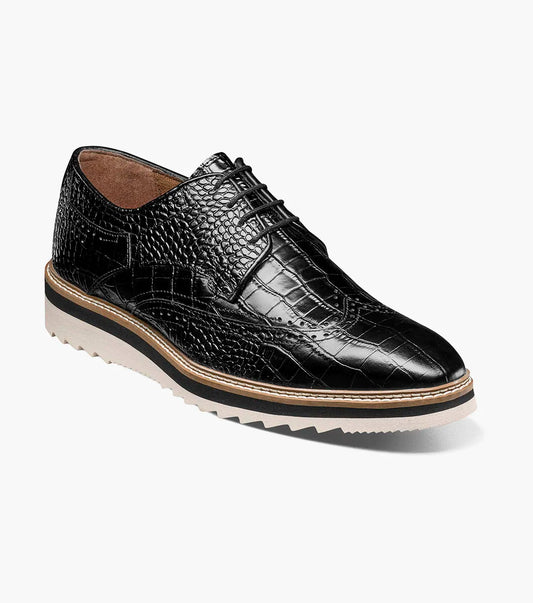 A black Stacy Adams Alario Wingtip Oxford (25725-001) is shown on a plain white background, featuring a molded heel cup, anatomical arch support, and a cushioned footbed for all-day comfort.