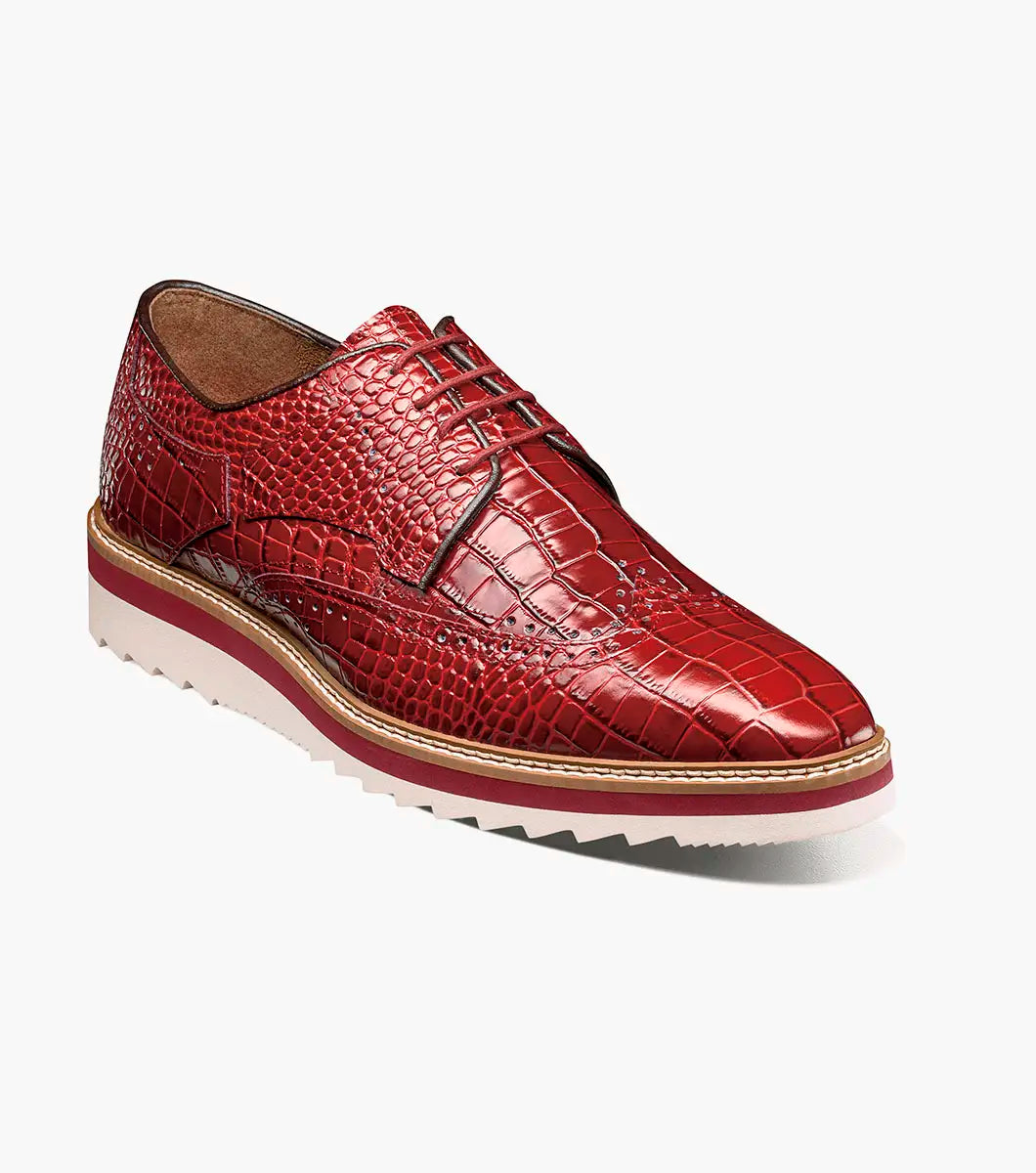 The Stacy Adams Alario Wingtip Oxford (25725-600) in red features crocodile print leather, brogue detailing, a white and tan EVA sole, and brown lining, shown on a plain white background.