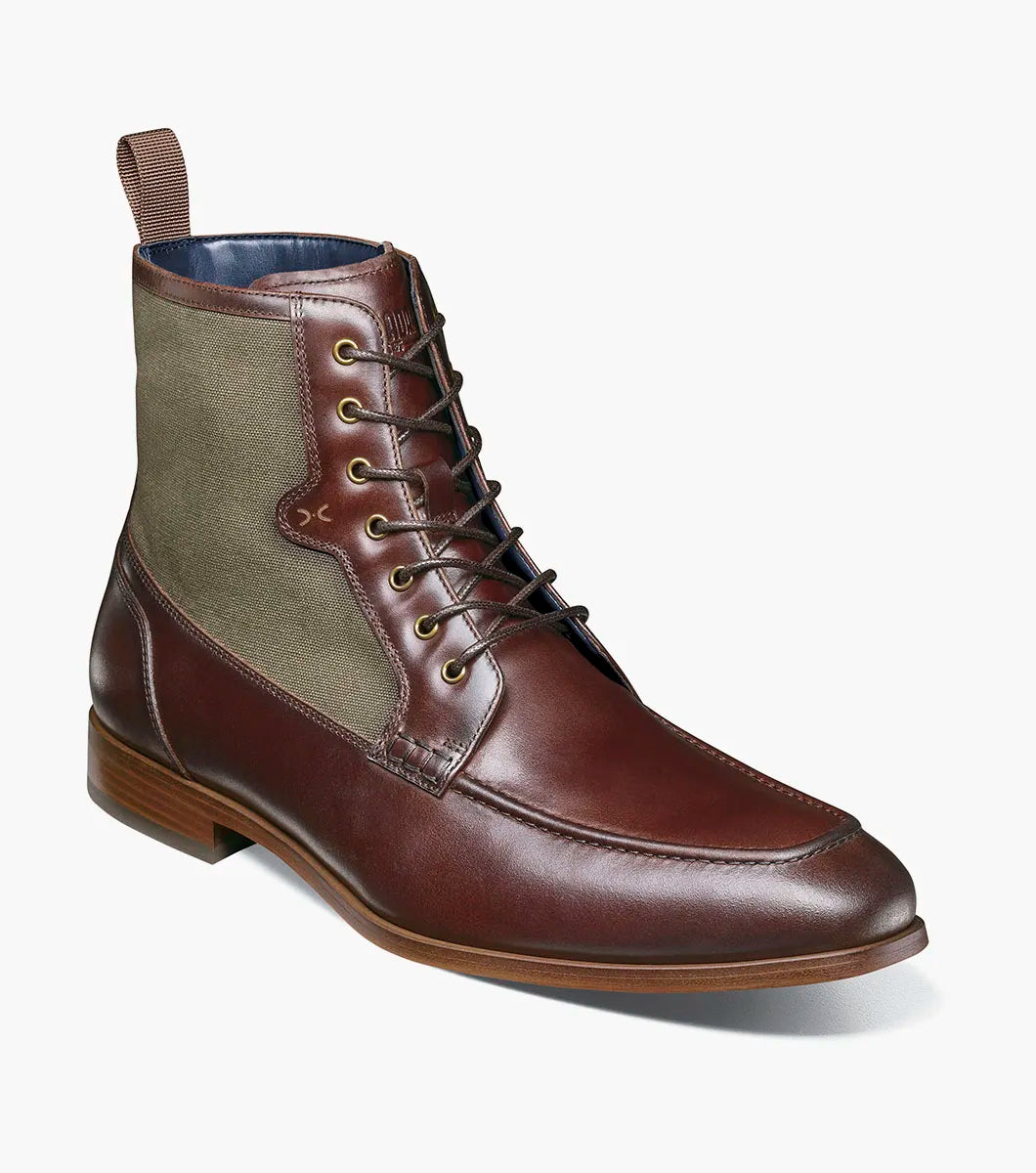 The Stacy Adams Brumley Moc Toe Lace Up Boot in Brown Multi features burnished leather and olive green fabric, a lace-up closure, cushioned footbed, and low stacked heel for lasting comfort and style.