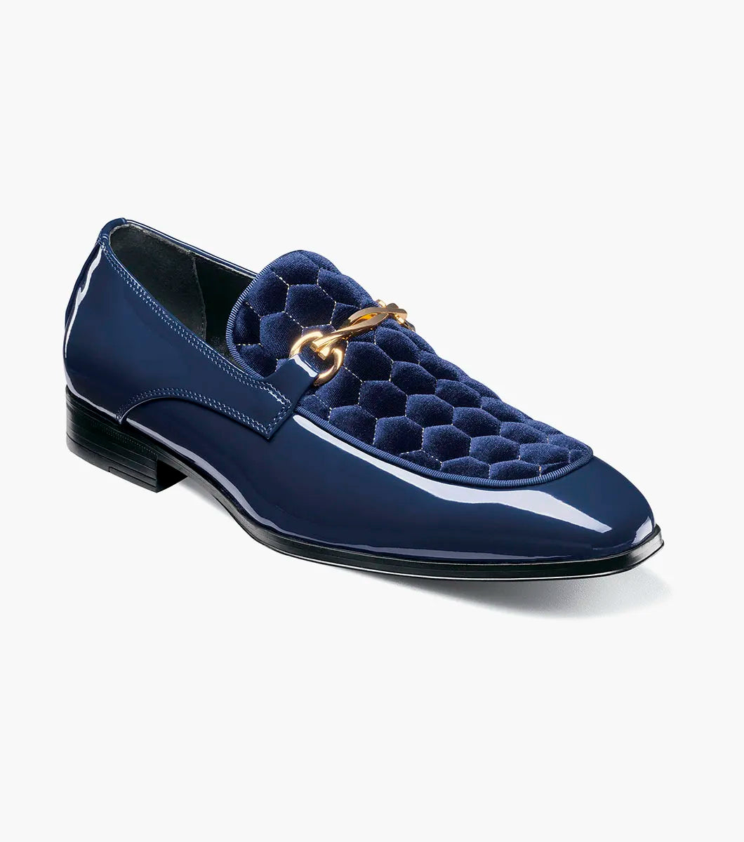 The STACY ADAMS Sprague Moc Toe Bit Slip On (Navy, 25732-410) is a men's loafer featuring a glossy hexagonal-patterned velvet upper and gold metal bit detail—ideal as stylish dress shoes.