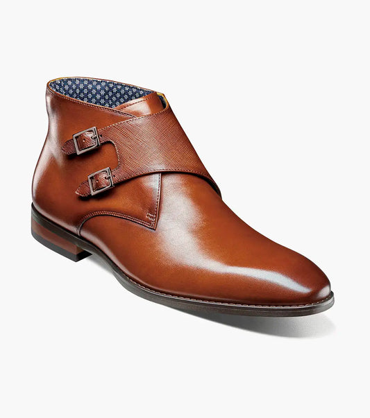 The STACY ADAMS Kaius Plain Toe Double Monk Strap Boot in Cognac (25733-221) features hand-burnished leather, a textured side panel, low stacked heel, and anatomical arch support, shown on a white background.