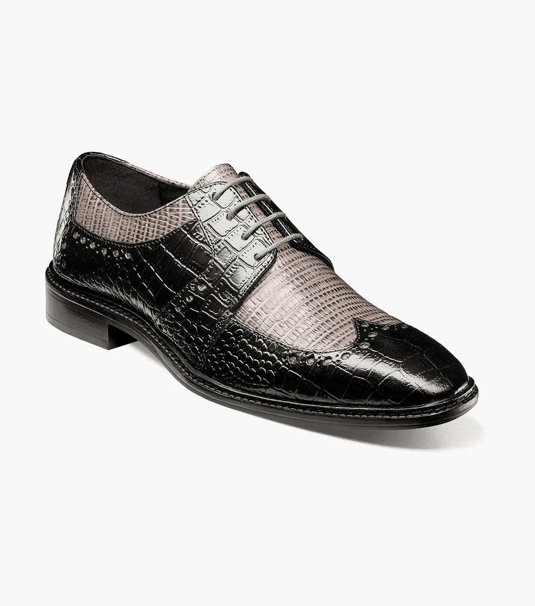 The Stacy Adams Travato Wingtip Oxford (Style 25737-975) in Black and Gray is a dress shoe expertly crafted from croco print leather, showcasing a distinctive crocodile and lizard pattern. This STACY ADAMS oxford features a lace-up design, low heel, and anatomical arch support, presented against a white background.