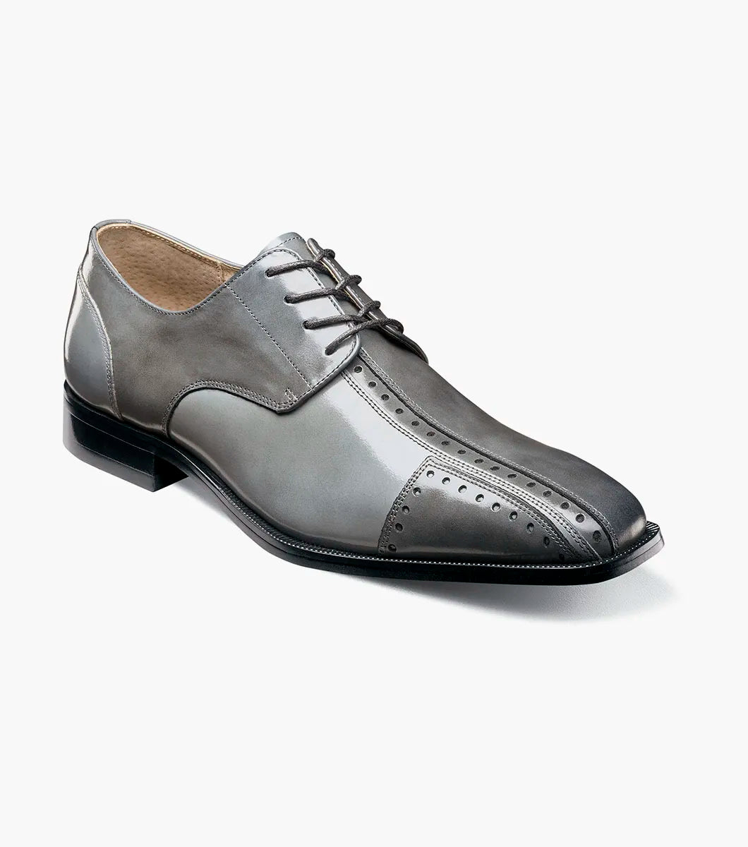 The STACY ADAMS Palmento Modified Cap Toe Oxford (Gray Multi, 25740-062) features decorative perforations, laces, a leather upper, and low heel, shown as a single dress shoe on a white background.