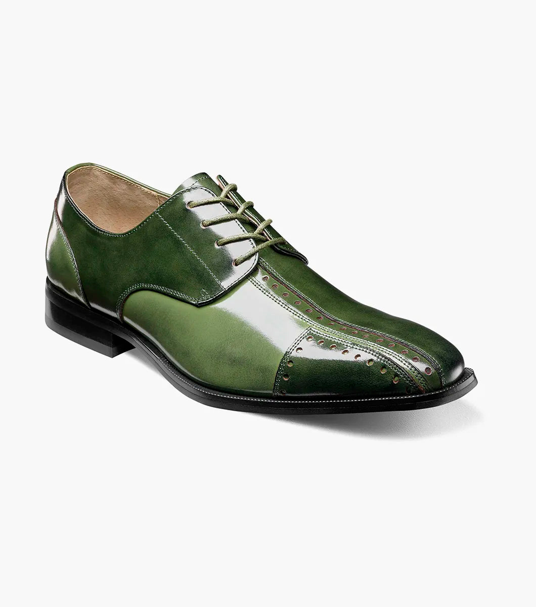 The Stacy Adams Palmento Modified Cap Toe Oxford in Green Multi (25740-340) features a leather upper, closed lacing, low black heel, decorative stitching and perforations, and is shown as a single shoe on a white background.