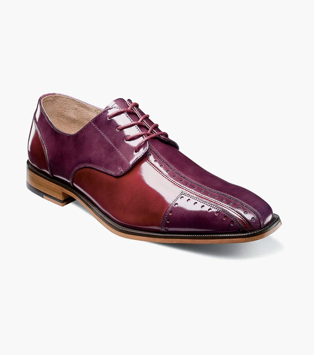 The STACY ADAMS Palmento Modified Cap Toe Oxford in Burgundy Multi (25740-641) features a polished leather upper, brogue accents, lace-up closure, Memory Foam insole, and wooden sole. Single shoe shown on white background.