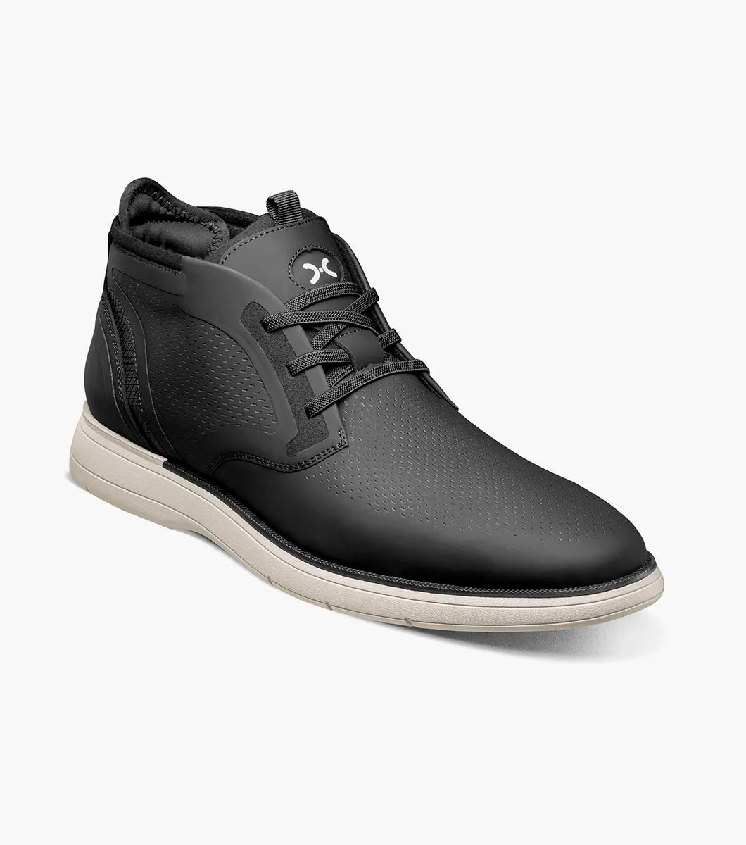 The STACY ADAMS Eastmont Plain Toe Elastic Lace Chukka Boot in black features a mid-top design, textured upper, elastic laces, white sole, and subtle logo on the tongue.