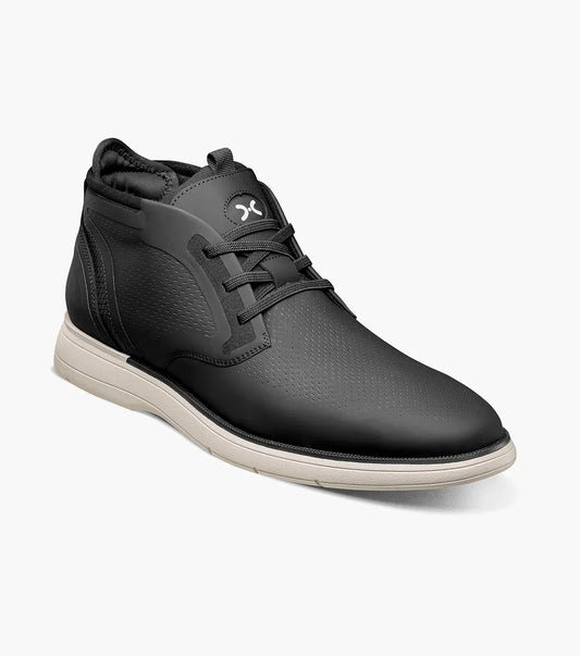The STACY ADAMS Eastmont Plain Toe Elastic Lace Chukka Boot in black features a mid-top design, textured upper, elastic laces, white sole, and subtle logo on the tongue.